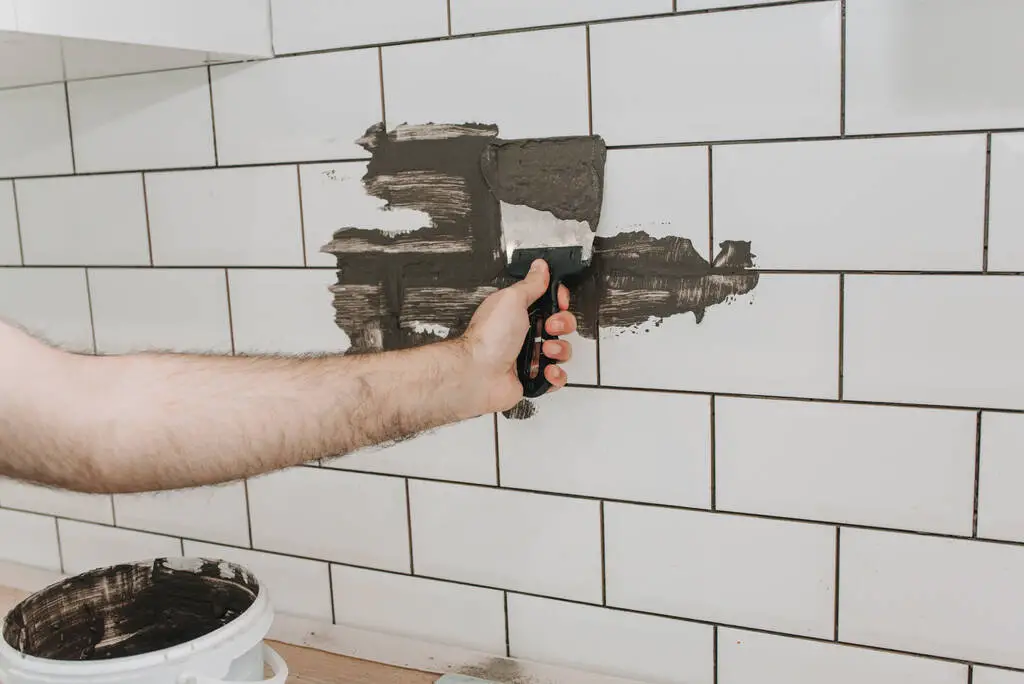 how to regrout tile without removing old grout